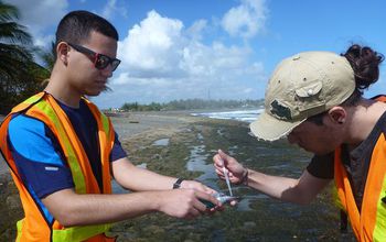 two citizen scientists collecting water samples